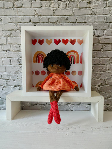 Theo the crochet doll in a display box